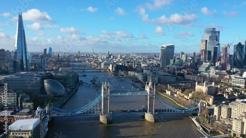 Aerial drone video of iconic Tower Bridge, Tower of London and skyline in financial area of City of London, United Kingdom photo