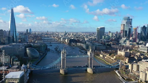 Aerial drone video of iconic Tower Bridge, Tower of London and skyline in financial area of City of London, United Kingdom