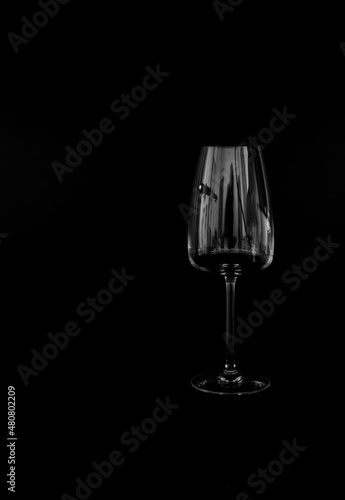 Black background and glass bottles with reflection on table