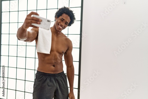 Young african american man smiling happy make selfie by the smartphone at gym