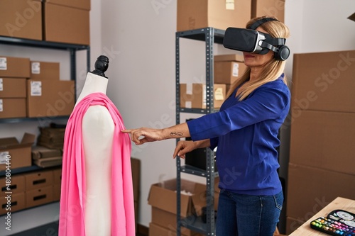 Middle age blonde woman business worker using virtual reality glasses at office