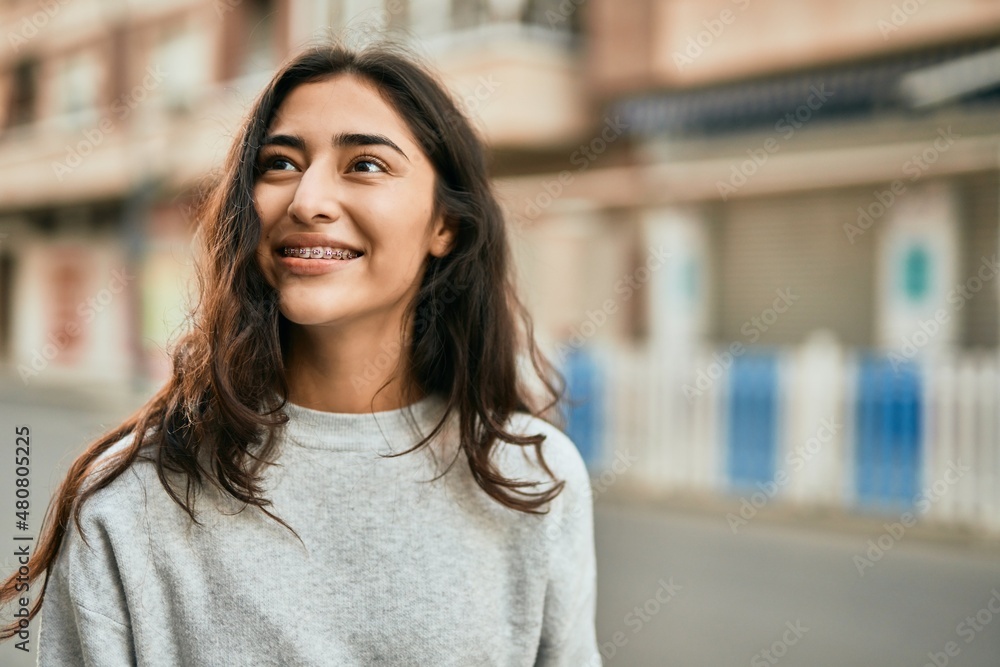 Young middle east girl smiling happy standing at the city. Young middle east girl smiling happy standing at the city.