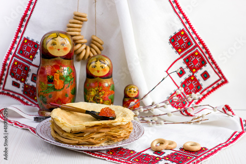 Background with pancakes, matryoshka, rushnik, sushki for Maslenitsa festival. photo