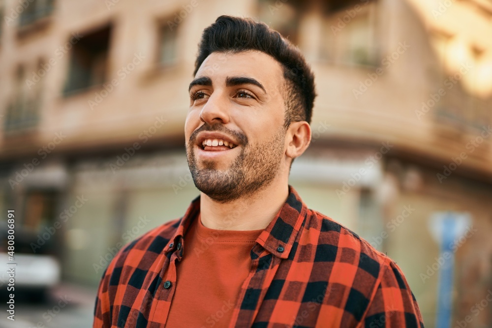 Young hispanic man smiling happy standing at the city. Young hispanic man smiling happy standing at the city.