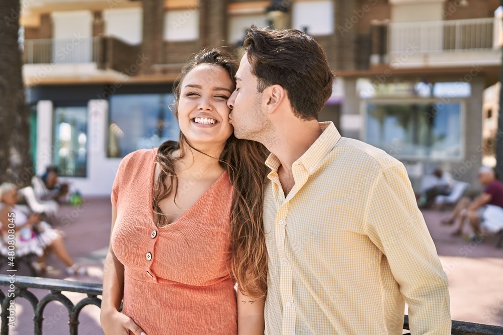 Man and woman couple hugging and kissing at street Man and woman couple hugging and kissing at street