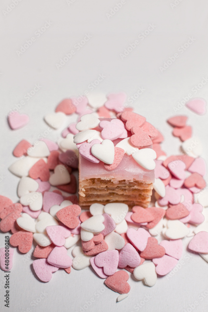 small cake sprinkled with decorative heart shaped sugar beads