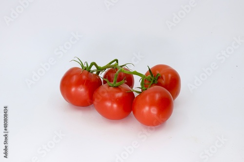 tomatoes on a vine © Hamad