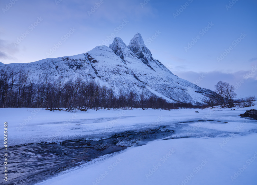 Frozen river and mountain. A classic view in Norway during winter. Otertind mountain, Norway. Landscape during sunset.