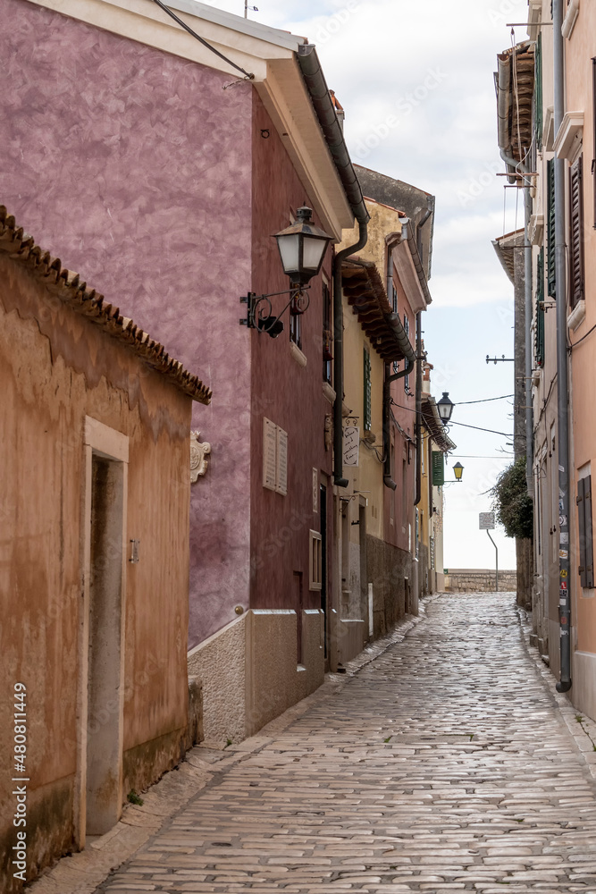 Empty, old, stone paved narrow streets of Rovinj, popular tourist destination with beautiful, colorful houses in the Istrian region of Croatia