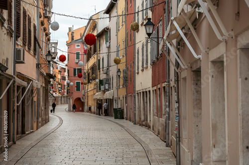 Tableau sur toile Colorful, stone paved Rovinj city streets, decorated with Christmas decoration