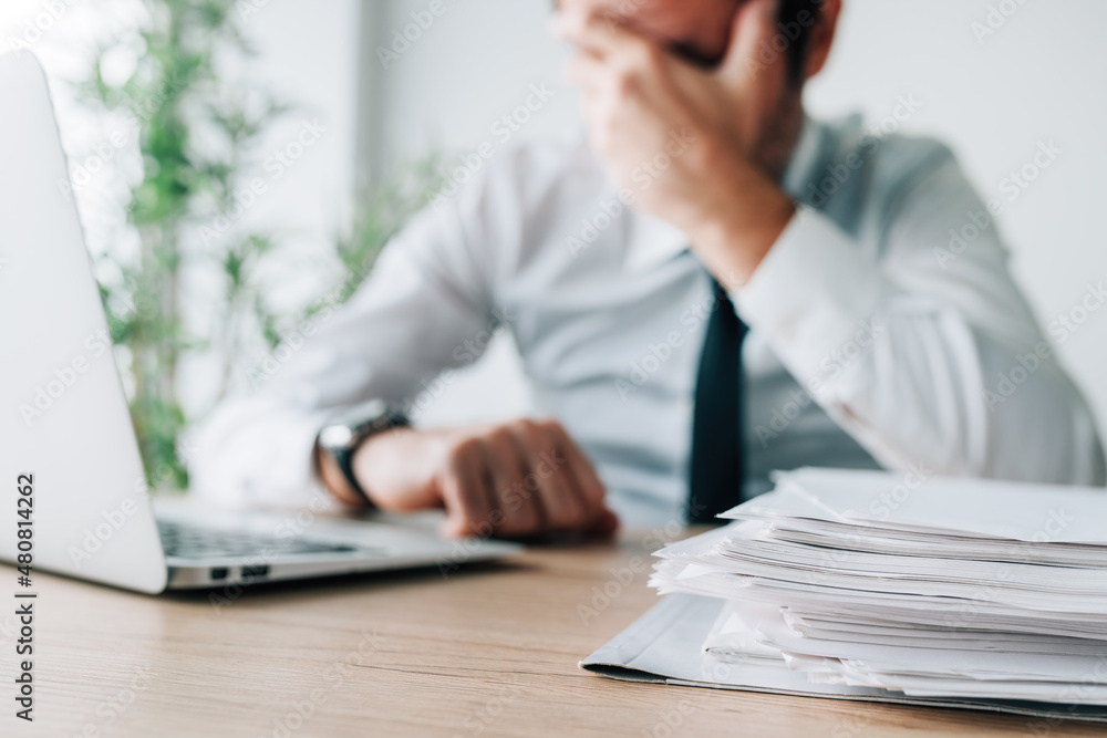 Career failure, disappointed businessman covering face in office Career failure, disappointed businessman covering face in office