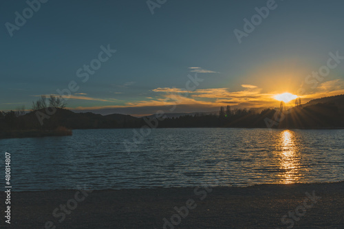 A picturesque landscape view of the Plan d'eau des Iscles lake next to Veynes (France) during the sunset photo