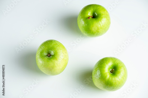 a whole green apple on a white background