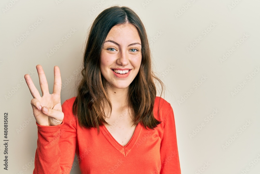 Young brunette woman wearing casual clothes showing and pointing up with fingers number three while smiling confident and happy. Young brunette woman wearing casual clothes showing and pointing up with fingers number three while smiling confident and happy.