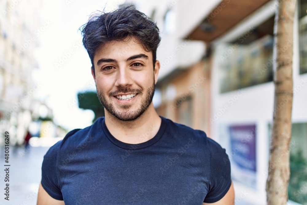 Young hispanic man smiling happy standing at the city. Young hispanic man smiling happy standing at the city.