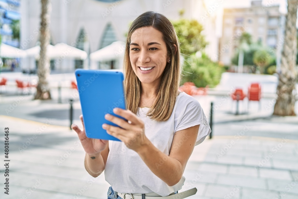 Young hispanic woman smiling confident using touchpad at street Young hispanic woman smiling confident using touchpad at street