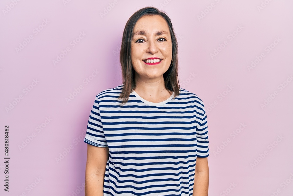 Middle age hispanic woman wearing casual clothes with a happy and cool smile on face. lucky person. Middle age hispanic woman wearing casual clothes with a happy and cool smile on face. lucky person.