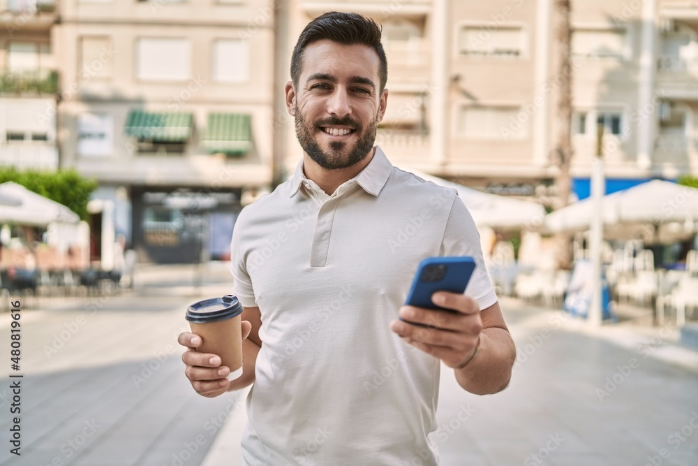 Young hispanic man using smartphone drinking coffee at street Young hispanic man using smartphone drinking coffee at street