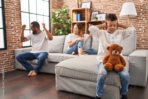 Family sitting on sofa and kid sad for partents argue at home photo