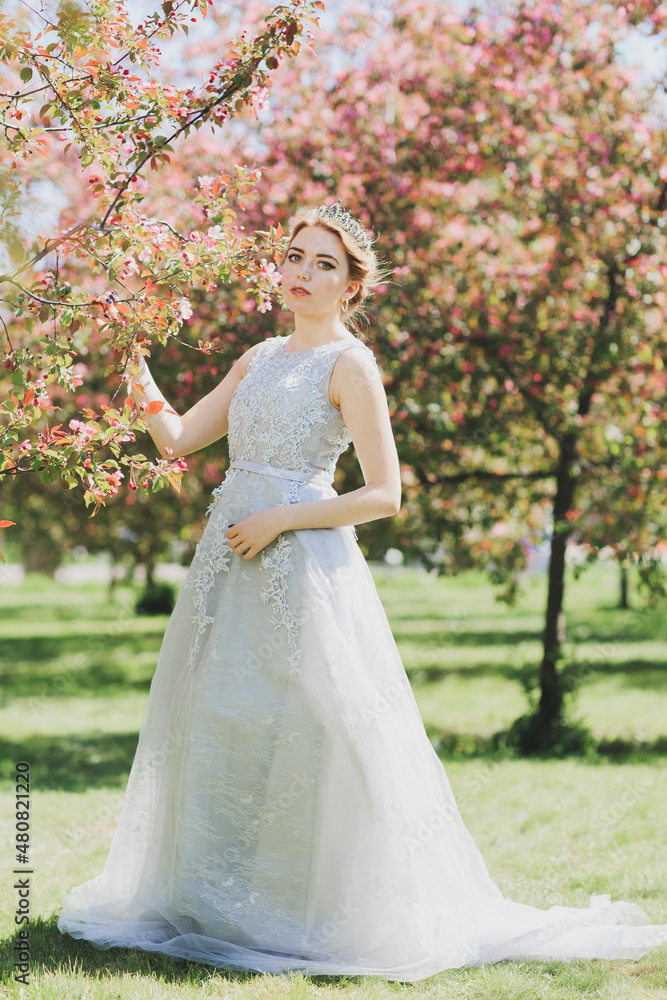 The beautiful woman in a dress with flowers.