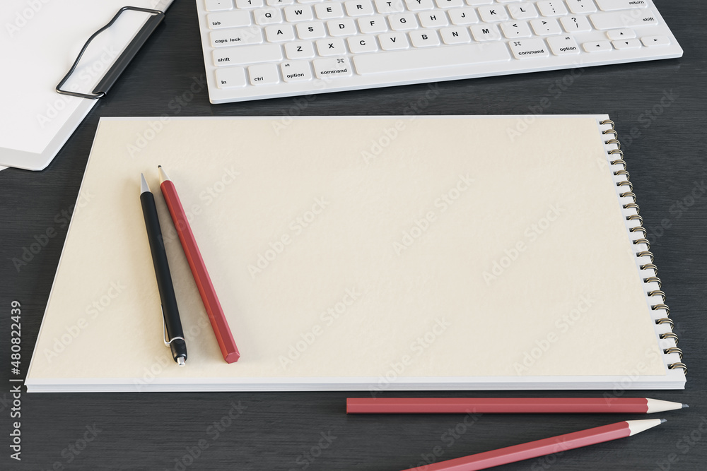 Top view of clean spiral notepad on dark wooden desktop with keyboard and pencils. Drawing, workplace, supplies and art concept. Mock up, 3D Rendering.
