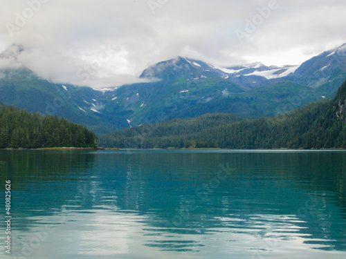 A Backwater Bay in Alaska Surrounded by a Conifer Forest and Mountains