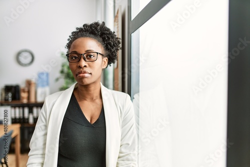 Fotografie African business woman working at the office thinking attitude and sober express