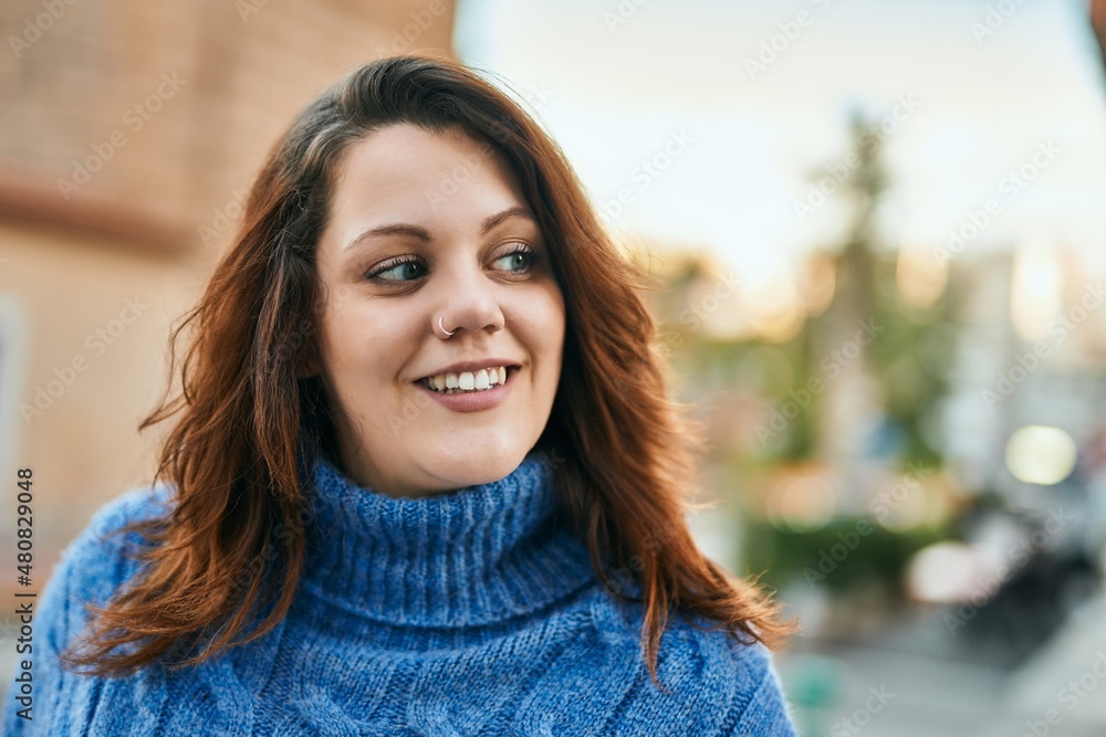 Young irish plus size girl smiling happy standing at the city. Young irish plus size girl smiling happy standing at the city.