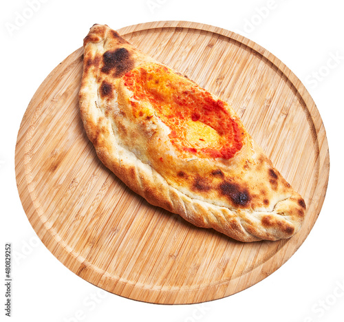 Photos Single calzone italian pizza on wooden plate isolated over white background