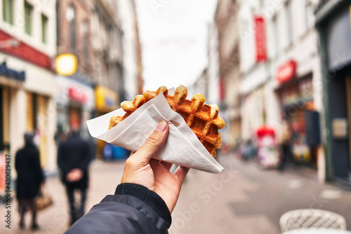  Hand of man holding waffle at street