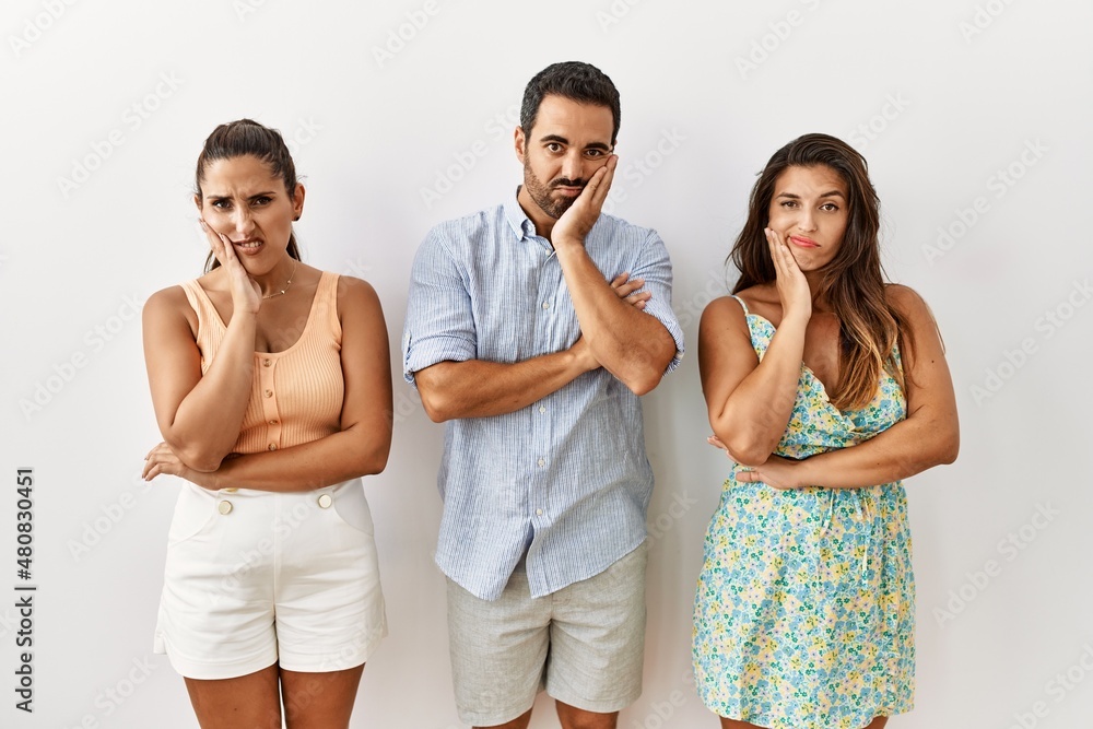Group of young hispanic people standing over isolated background thinking looking tired and bored with depression problems with crossed arms. Group of young hispanic people standing over isolated background thinking looking tired and bored with depression problems with crossed arms.