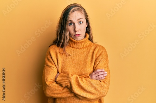 Young blonde woman with arms crossed gesture skeptic and nervous, frowning upset because of problem. negative person. © Krakenimages.com