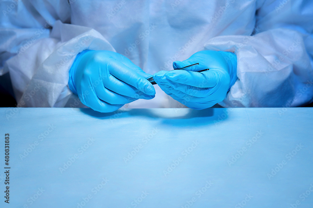 Close-up of the surgeon's hands with the instrument. Medicine, veterinary medicine or medical care and emergency care in a hospital Close-up of the surgeon's hands with the instrument. Medicine, veterinary medicine or medical care and emergency care in a hospital