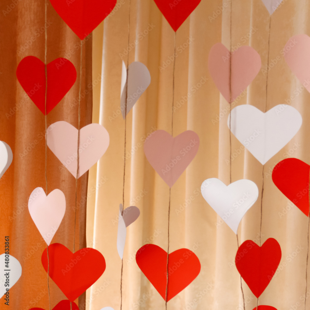 Defocus banner. Valentines Day background with paper hearts. The red and white heart shapes for 14 February. Love concept. Cupid's bow. Square backdrop. Holiday concept. Copy space. Out of focus