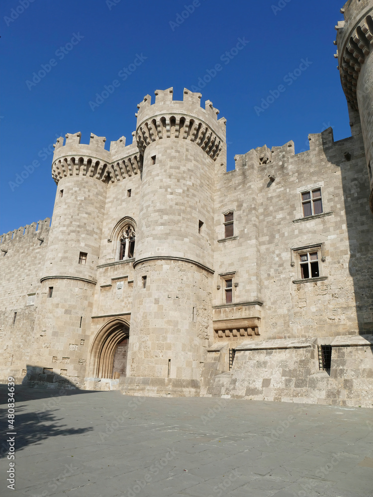 Massive medieval walls and towers guard  Palace of the Grand Master
