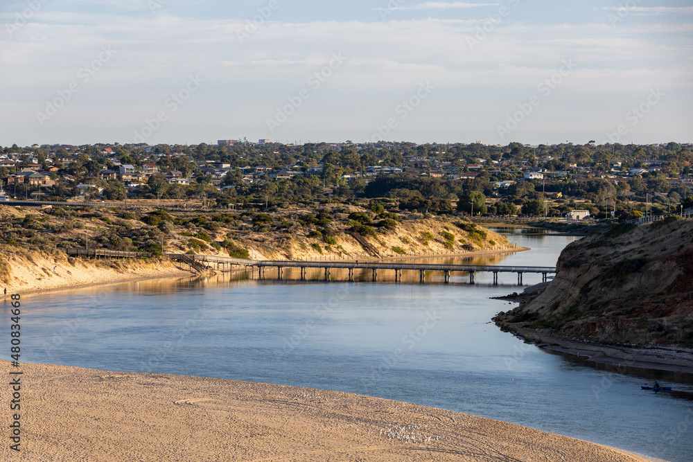 Sunrise over the onkaparinga river foot bridge located at port noarlunga south australia on january 16th 2022