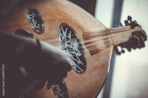 Musician Playing Note on Instrument Oud