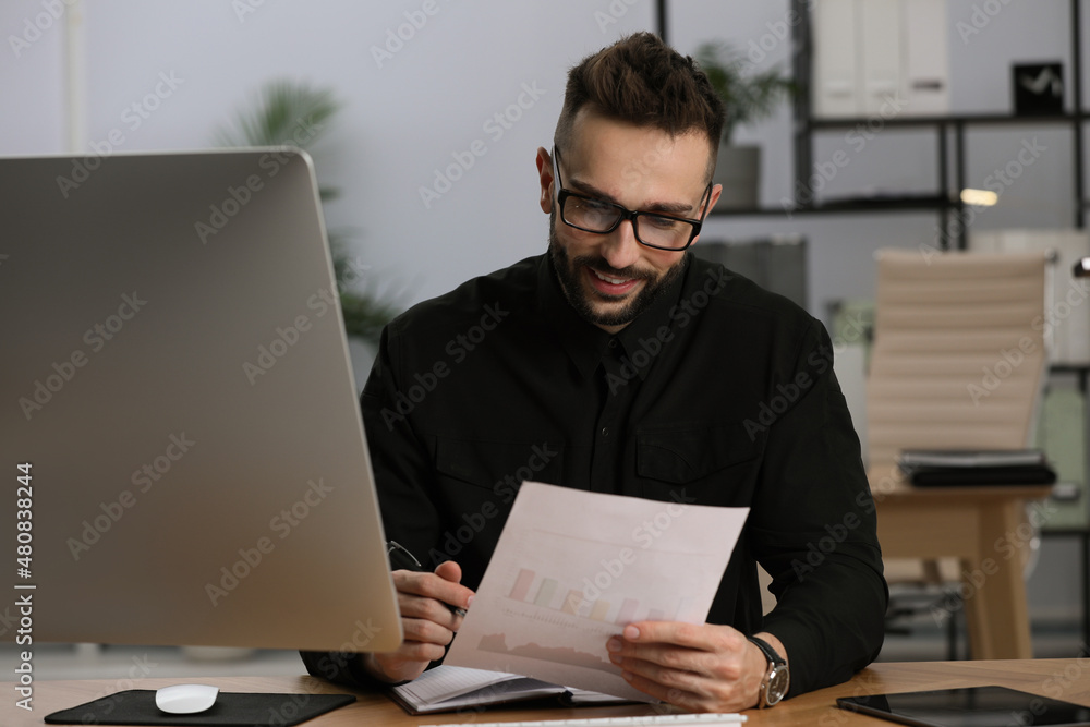 Man working with document at table in office Man working with document at table in office