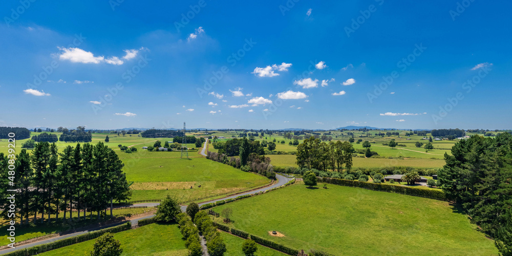 Aerial drone view over lush green farmland in the Waikato region of New Zealand