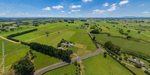 Aerial drone view over lush green farmland in the Waikato region of New Zealand