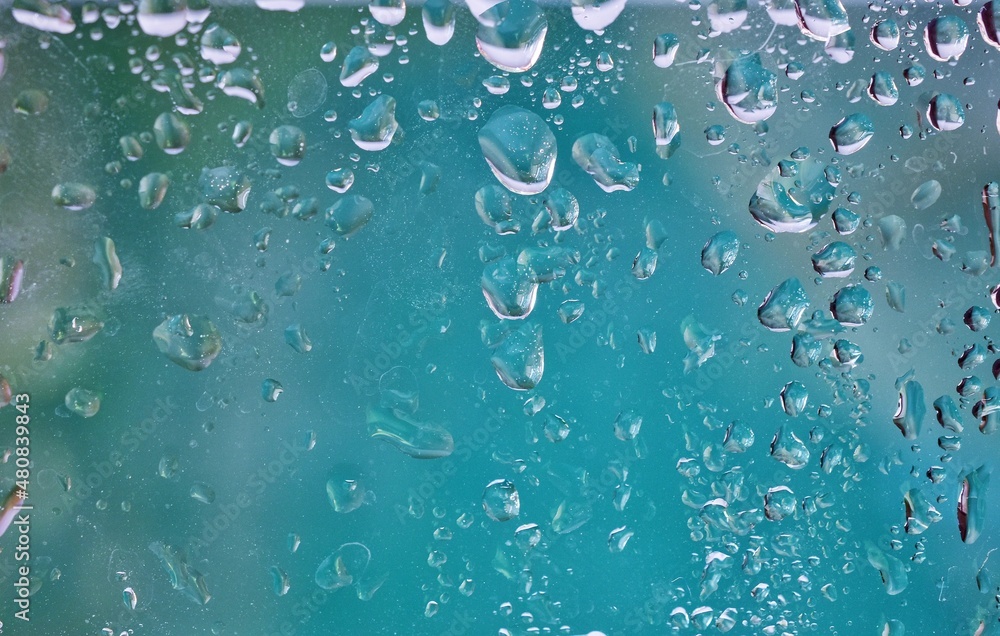 water droplets on glass blue background bright abstract