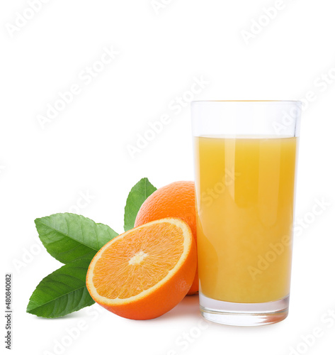 Glass of orange juice, fresh fruits and green leaves on white background