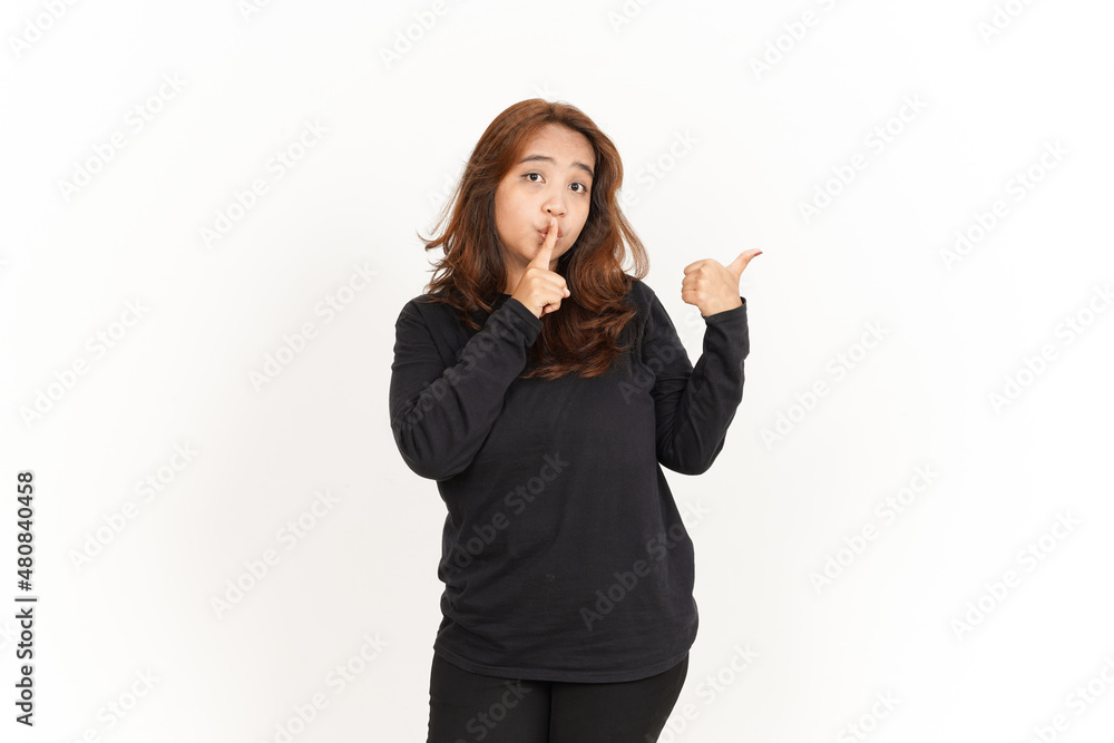 Pointing product with thumb Of Beautiful Asian Woman Wearing Black Shirt Isolated On White Pointing product with thumb Of Beautiful Asian Woman Wearing Black Shirt Isolated On White