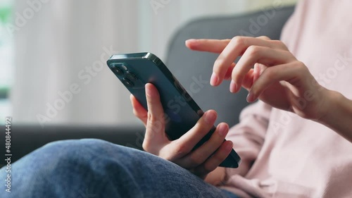 Hand holding smartphone and chatting online on mobile, During leisure time.