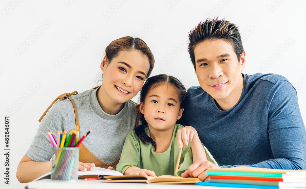 Portrait enjoy happy love asian family father and mother with little asian girl learn and study on table.Mom and dad with young girl writing with book make homework in homeschool at home.Education Portrait enjoy happy love asian family father and mother with little asian girl learn and study on table.Mom and dad with young girl writing with book make homework in homeschool at home.Education