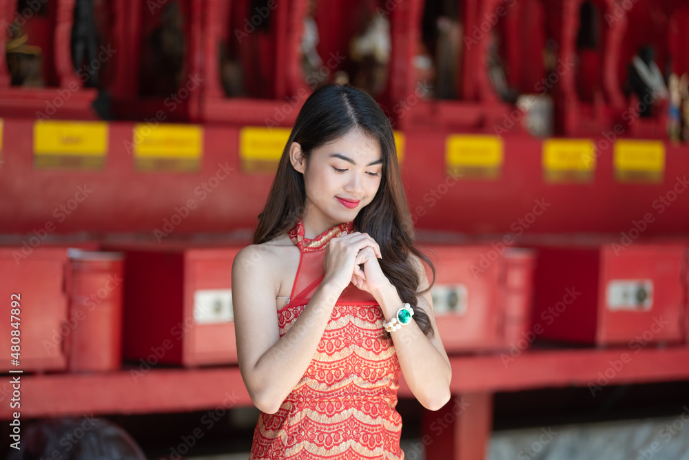 Beautiful Asian woman with congratulate gesture in Chinese New Year