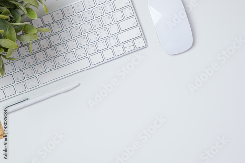 top view working desk with keyboard mouse and notebook on white table backgorund
