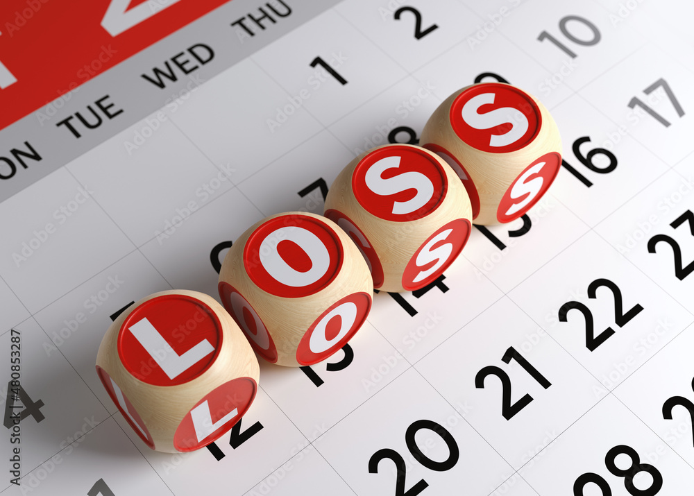 Tiny wood blocks with loss text. On white-colored calendar page. Horizontal composition with copy space. Focused image. Tiny wood blocks with loss text. On white-colored calendar page. Horizontal composition with copy space. Focused image.