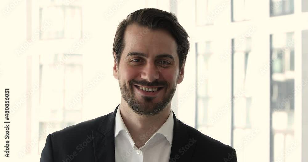 Head shot of smiling confident businessman in formal suit looking at camera posing in office. Human resources, HR manager, company CEO, successful staff member, leader portrait, career growth concept Head shot of smiling confident businessman in formal suit looking at camera posing in office. Human resources, HR manager, company CEO, successful staff member, leader portrait, career growth concept