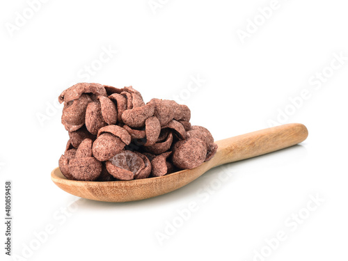 chocolate cornflakes in wooden spoon isolated on white background, dry morning breakfast